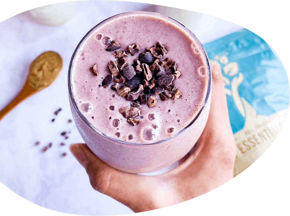 A person enjoying a decadent JB Syrups milkshake with chocolate and chocolate chips.