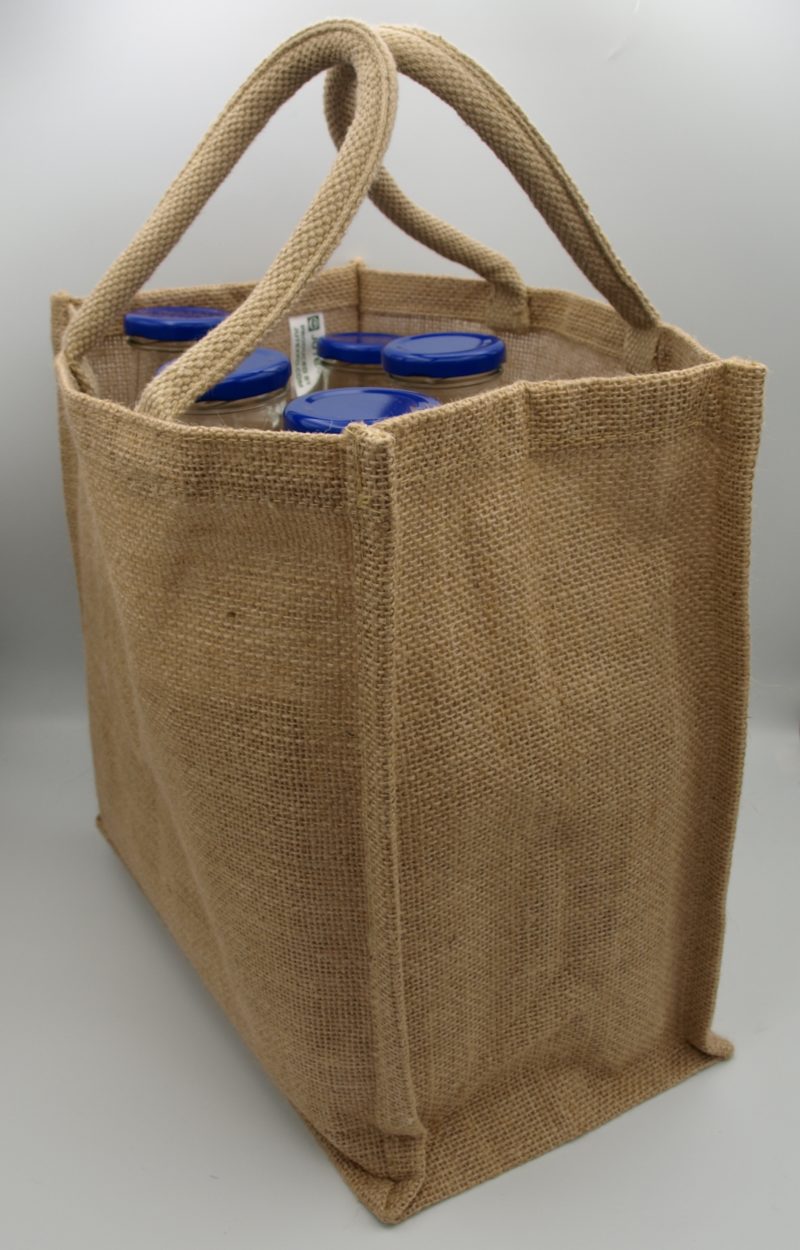 A Handy 6 Bottle Carrier With Divider – Jute shopping bag with blue handles, perfect for carrying your JB Syrups or Milkshake.